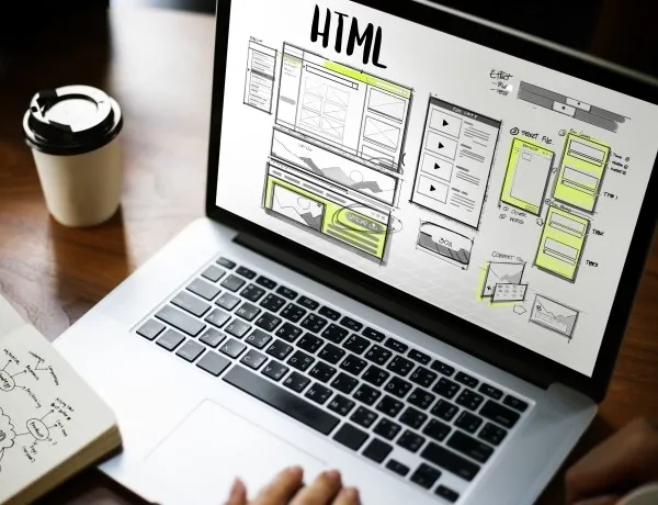 HTML wireframe on laptop highlighting the benefits of working with a creative design agency